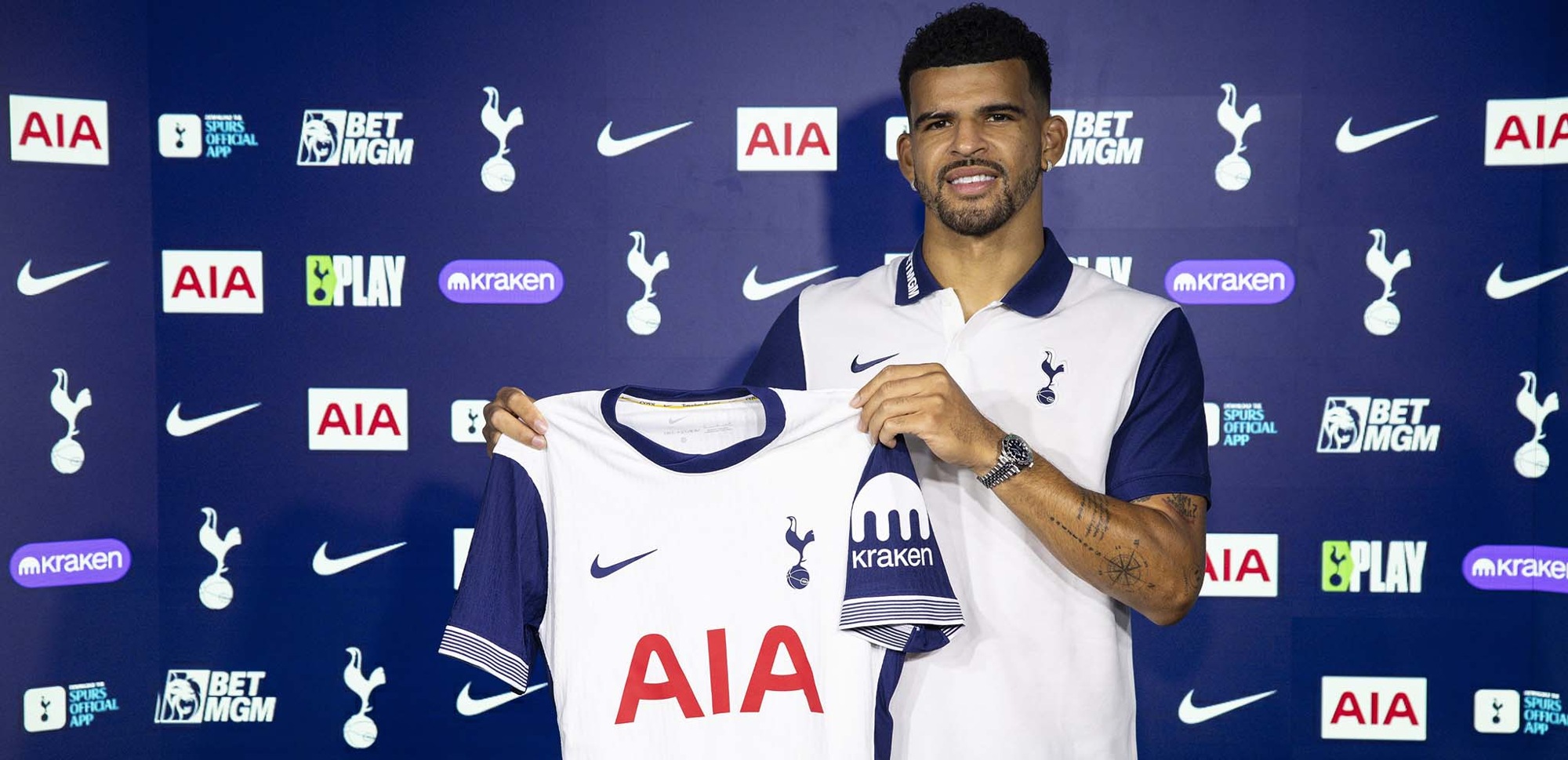 Dominic Solanke holding a Tottenham Hotspur shirt in an archive signing photo