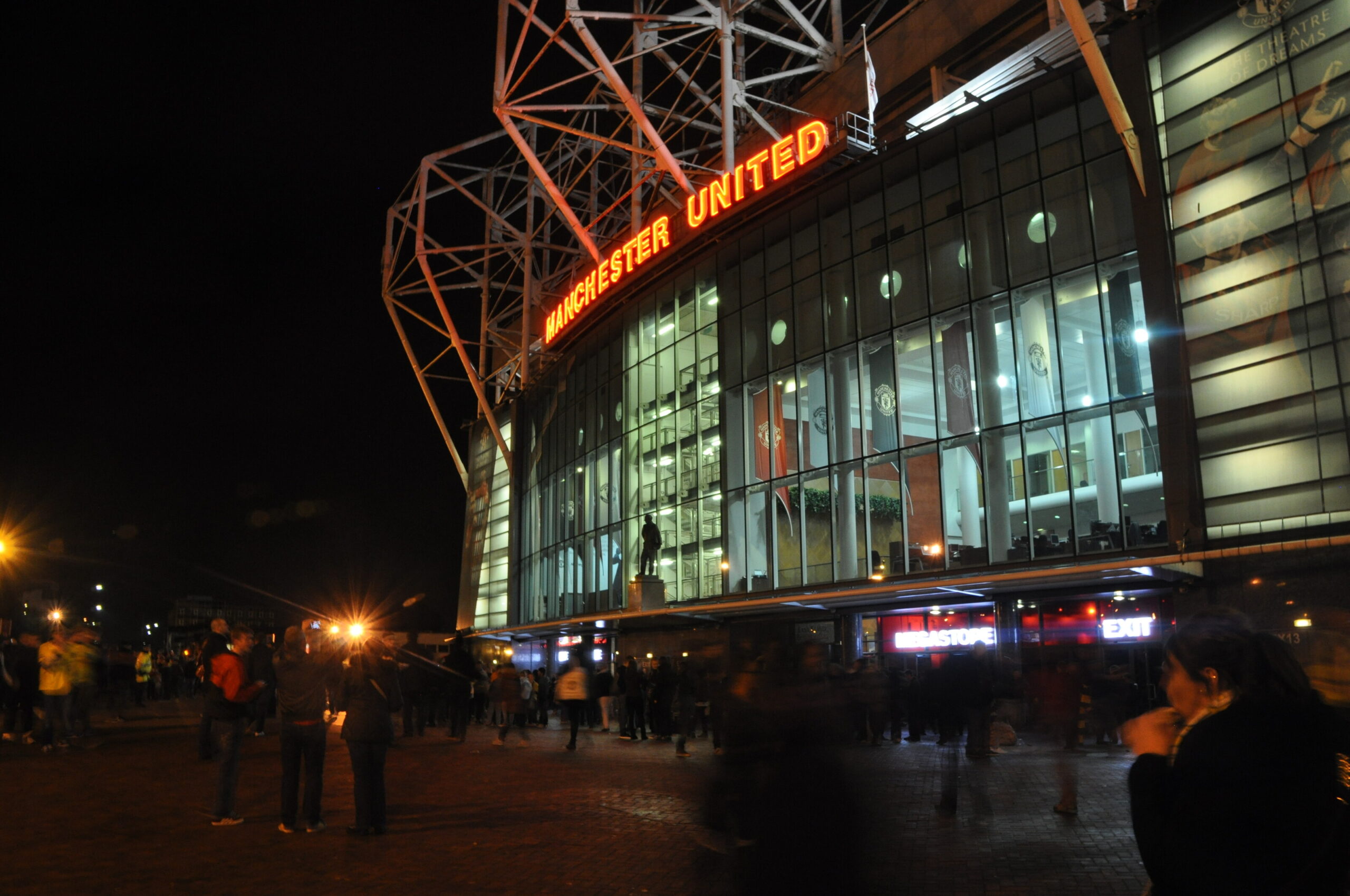 Old Trafford at night, where Man United v Spurs is played on Saturday